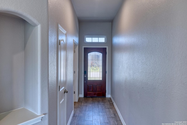 13 Hope, Uvalde, TX 78801 - doorway featuring a textured wall, dark wood-style flooring, and arched walkways