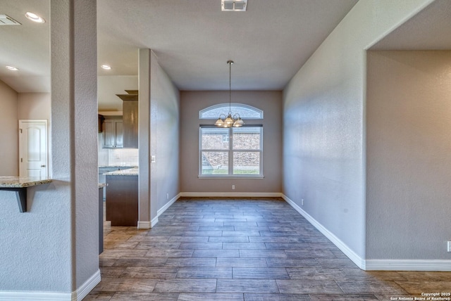 13 Hope, Uvalde, TX 78801 - unfurnished dining area with wood finished floors, a chandelier, and recessed lighting