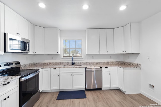 502 E Palfrey, San Antonio, TX 78223 - kitchen featuring stainless steel appliances, light wood-type flooring, white cabinets, light stone countertops, and recessed lighting