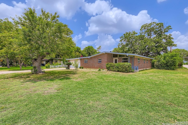 142 Winn, Universal City, TX 78148 - view of side of property with brick siding and a yard