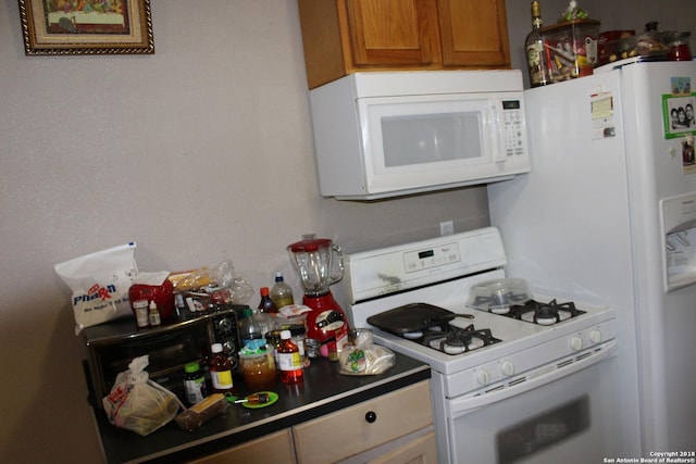 401 W Lindbergh Blvd, Universal City, TX 78148 - kitchen featuring white appliances and brown cabinets