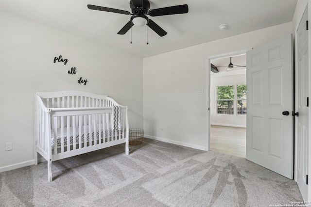 333 S Mesquite, New Braunfels, TX 78130 - bedroom featuring carpet flooring, ceiling fan, and a crib