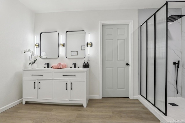 333 S Mesquite, New Braunfels, TX 78130 - bathroom featuring a marble finish shower, double vanity, and wood finished floors