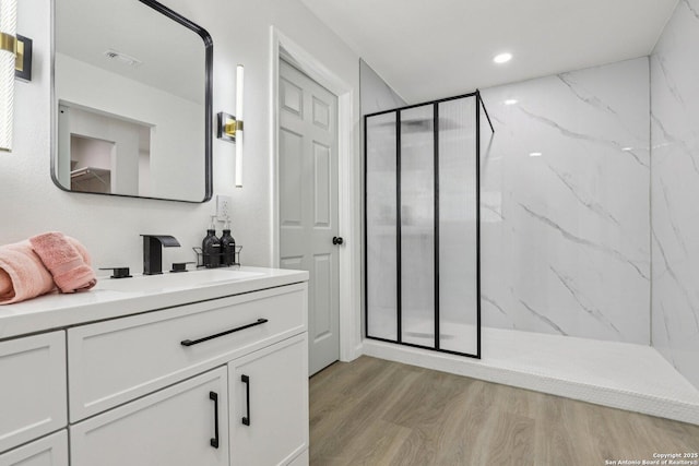 333 S Mesquite, New Braunfels, TX 78130 - bathroom featuring a marble finish shower, vanity, wood finished floors, and recessed lighting