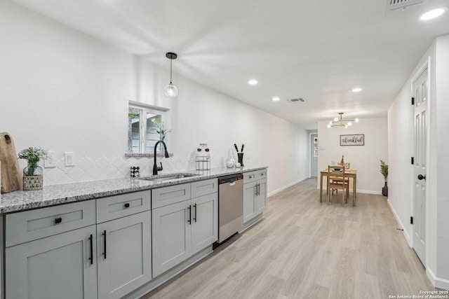 333 S Mesquite, New Braunfels, TX 78130 - kitchen featuring dishwasher, light wood-type flooring, recessed lighting, a chandelier, and light stone counters