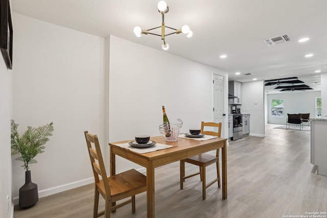 333 S Mesquite, New Braunfels, TX 78130 - dining room featuring light wood finished floors, recessed lighting, and a chandelier