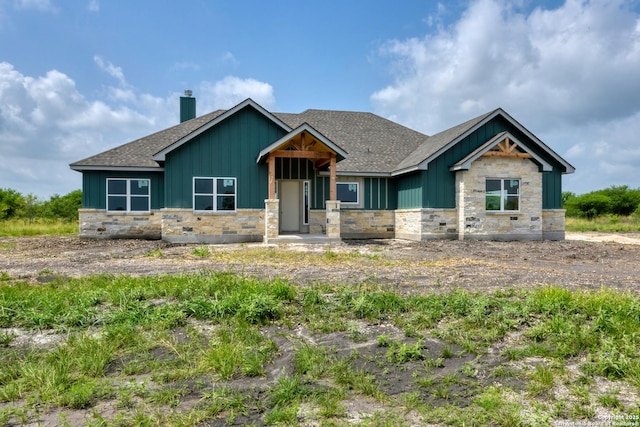 133 Wild Persimmon Trl, Marion, TX 78124 - craftsman-style home featuring stone siding, board and batten siding, a shingled roof, and a chimney
