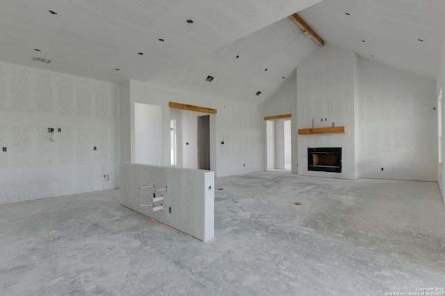 133 Wild Persimmon Trl, Marion, TX 78124 - unfurnished living room with a fireplace, concrete floors, high vaulted ceiling, and beam ceiling