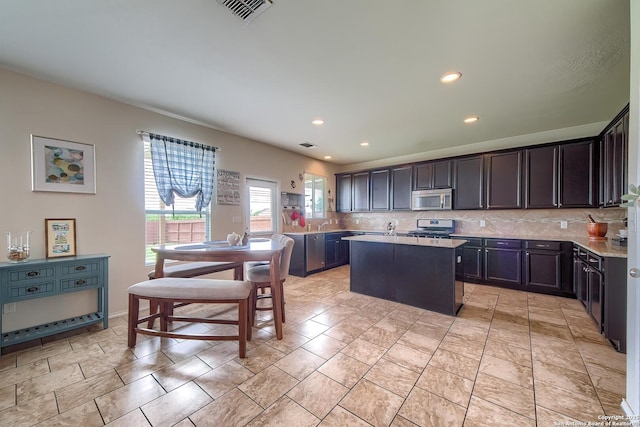 12870 Limestone, San Antonio, TX 78253 - kitchen featuring appliances with stainless steel finishes, tasteful backsplash, light countertops, a center island with sink, and recessed lighting