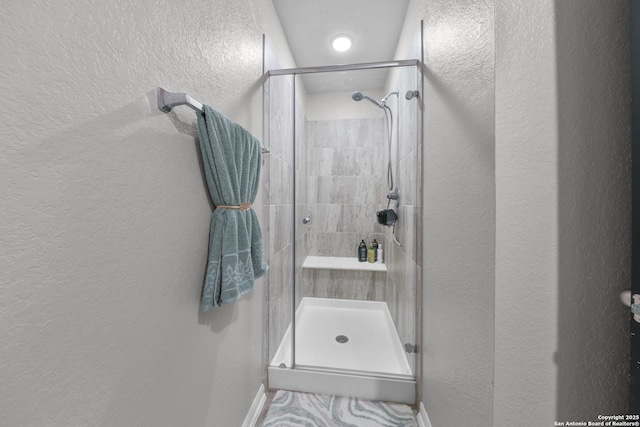 141 Whitetail Pass, San Antonio, TX 78253 - full bathroom featuring a stall shower and a textured wall