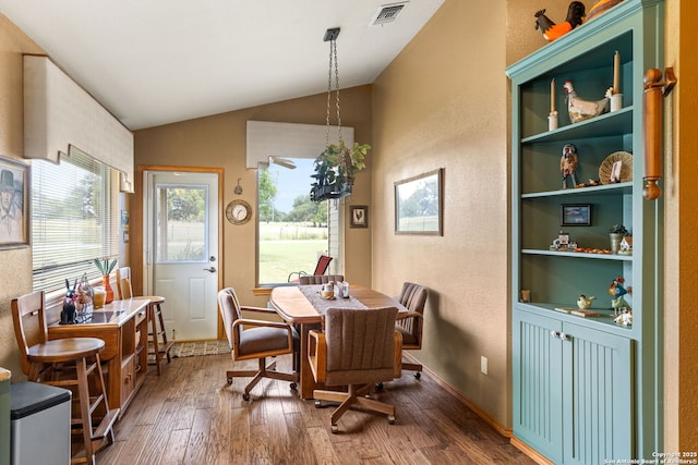 479 Park Rd 23, Blanco, TX 78606 - dining area with wood-type flooring, vaulted ceiling, and a textured wall
