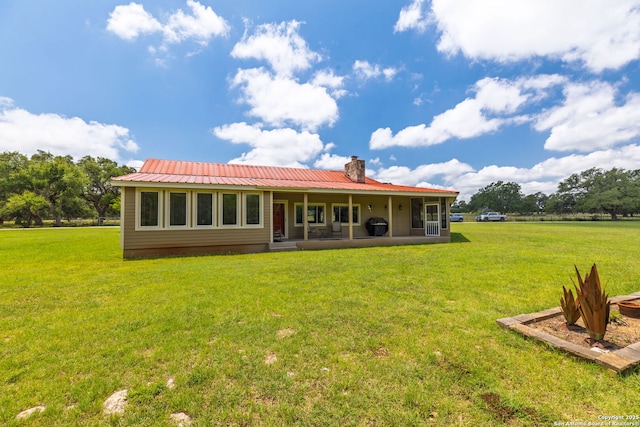 479 Park Rd 23, Blanco, TX 78606 - rear view of property featuring a yard, a chimney, and a metal roof