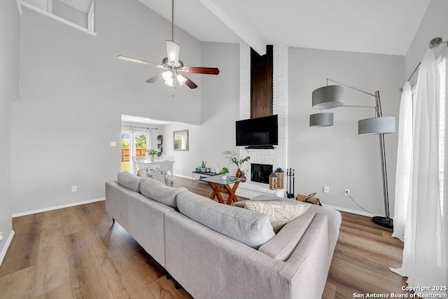 808 Fern Mdw, Universal City, TX 78148 - living room featuring high vaulted ceiling, wood finished floors, a ceiling fan, a brick fireplace, and beamed ceiling