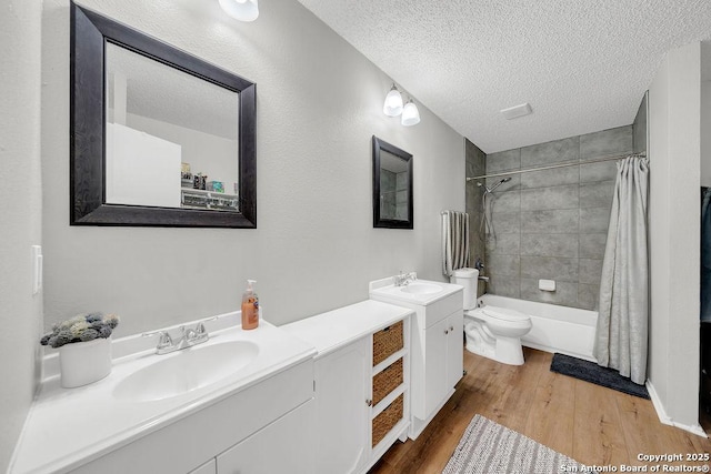 808 Fern Mdw, Universal City, TX 78148 - full bath featuring wood finished floors, vanity, shower / bathtub combination with curtain, and a textured ceiling