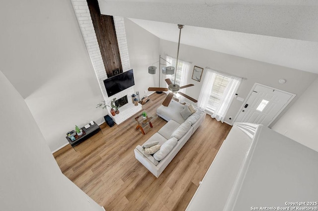 808 Fern Mdw, Universal City, TX 78148 - living area featuring wood finished floors, high vaulted ceiling, a ceiling fan, and a fireplace