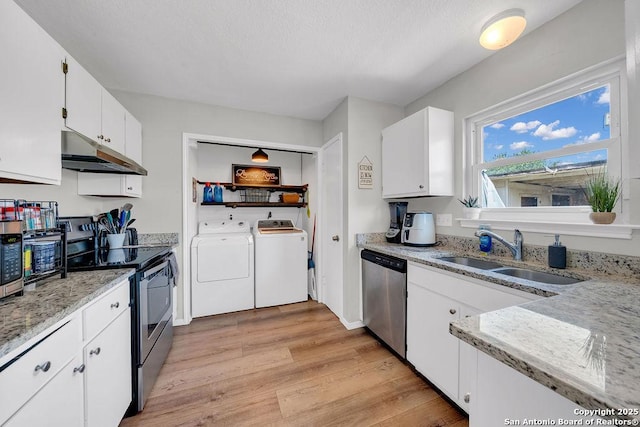 808 Fern Mdw, Universal City, TX 78148 - kitchen featuring stainless steel appliances, under cabinet range hood, washer and clothes dryer, light wood-style flooring, and white cabinets