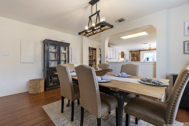11862 Barkston, San Antonio, TX 78253 - dining area featuring arched walkways, a chandelier, and dark wood-type flooring