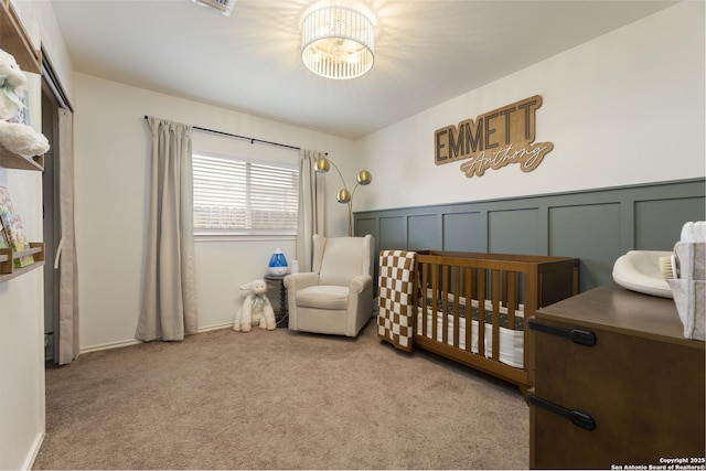 11862 Barkston, San Antonio, TX 78253 - carpeted bedroom featuring a chandelier, a crib, and wainscoting