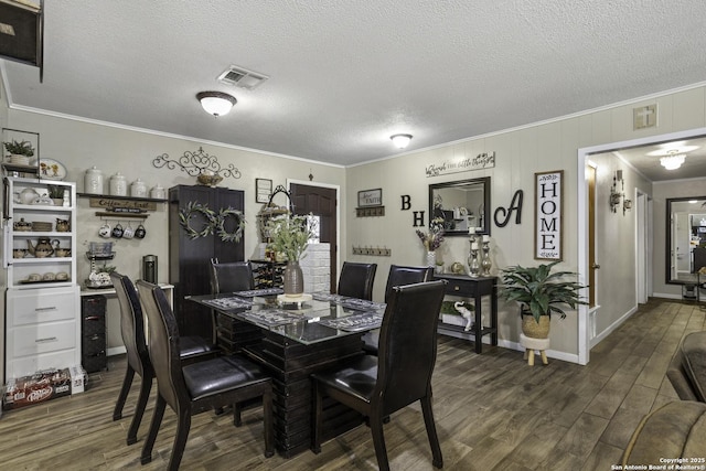 1245 Whitney, Pleasanton, TX 78064 - dining room featuring crown molding, dark wood-type flooring, and a textured ceiling