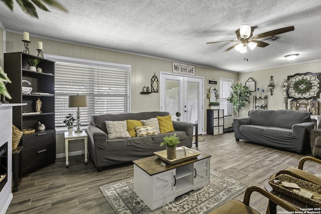 1245 Whitney, Pleasanton, TX 78064 - living area featuring ceiling fan, wood finished floors, french doors, and a textured ceiling