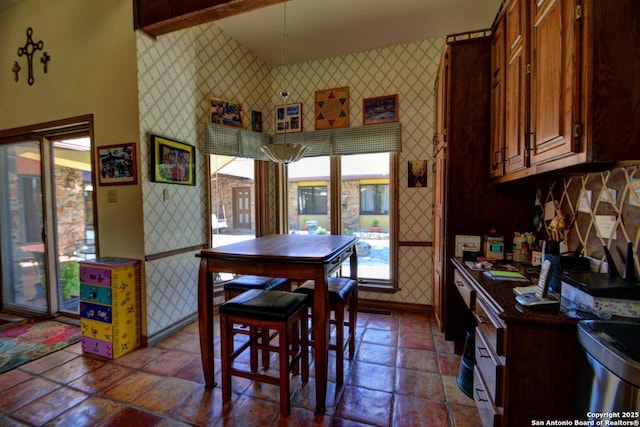 142 Four Bears Trl, Kerrville, TX 78028 - dining space with wallpapered walls and stone tile flooring