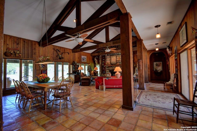 142 Four Bears Trl, Kerrville, TX 78028 - dining space with wooden walls, beamed ceiling, a ceiling fan, arched walkways, and high vaulted ceiling