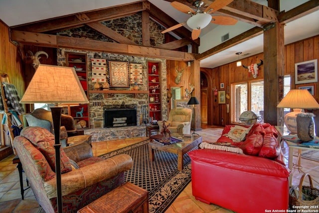 142 Four Bears Trl, Kerrville, TX 78028 - living room with wooden walls, a ceiling fan, high vaulted ceiling, a stone fireplace, and beamed ceiling