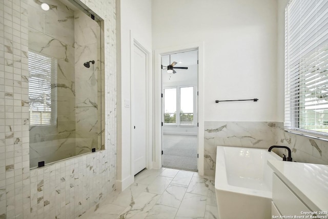 409 Dulce Vis, Boerne, TX 78006 - bathroom with a freestanding bath, healthy amount of natural light, a marble finish shower, marble look tile flooring, and tile walls
