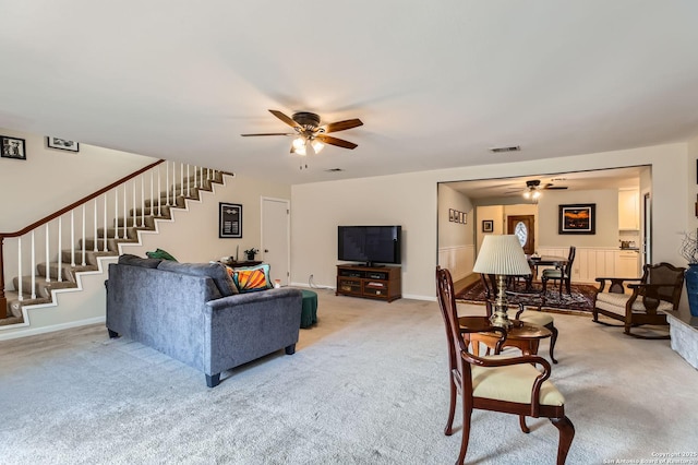 547 Patricia, San Antonio, TX 78216 - living room featuring a ceiling fan, stairway, and light colored carpet