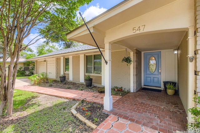 547 Patricia, San Antonio, TX 78216 - view of exterior entry featuring brick siding and a garage