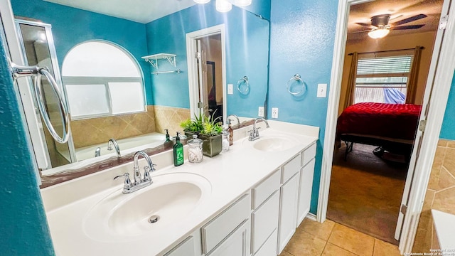 12339 Craddick Cv, San Antonio, TX 78254 - ensuite bathroom featuring tile patterned floors, a bath, double vanity, and a ceiling fan