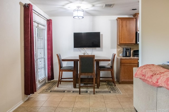 12339 Craddick Cv, San Antonio, TX 78254 - dining area featuring light tile patterned floors and baseboards