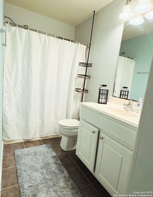 5742 Butch Cyn, San Antonio, TX 78252 - bathroom featuring tile patterned flooring, vanity, a textured wall, and curtained shower