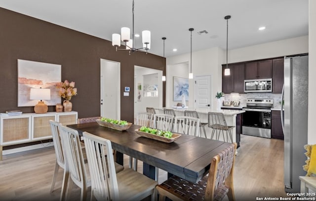 6651 Comanche Vly, San Antonio, TX 78233 - dining area featuring light wood-style flooring, a chandelier, and recessed lighting