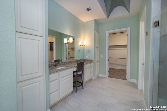 12 Denbury Gln, San Antonio, TX 78257 - bathroom featuring a walk in closet, vanity, and a chandelier