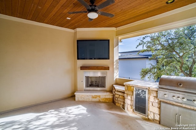 12 Denbury Gln, San Antonio, TX 78257 - view of patio / terrace featuring wine cooler, a fireplace, exterior kitchen, and a ceiling fan