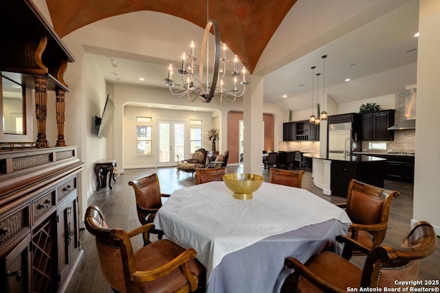 12 Denbury Gln, San Antonio, TX 78257 - dining area with arched walkways, dark wood-style floors, lofted ceiling, a chandelier, and recessed lighting