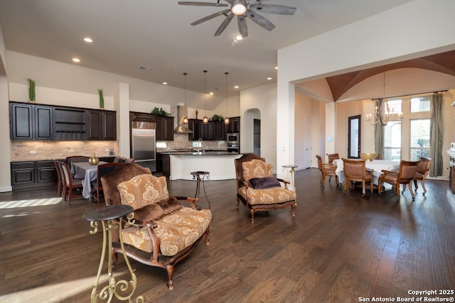 12 Denbury Gln, San Antonio, TX 78257 - living area featuring arched walkways, a ceiling fan, dark wood finished floors, a chandelier, and recessed lighting