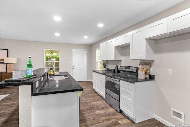8810 Flint Vly, San Antonio, TX 78227 - kitchen featuring stainless steel electric range oven, white cabinetry, dark wood-type flooring, healthy amount of natural light, and recessed lighting