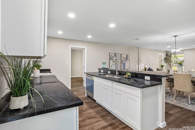 8810 Flint Vly, San Antonio, TX 78227 - kitchen featuring stainless steel dishwasher, white cabinetry, dark wood finished floors, recessed lighting, and an island with sink