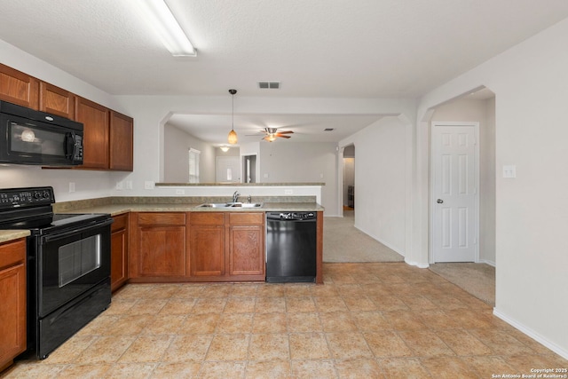 9218 Pacific Maple, San Antonio, TX 78254 - kitchen featuring black appliances, a peninsula, brown cabinets, and a ceiling fan