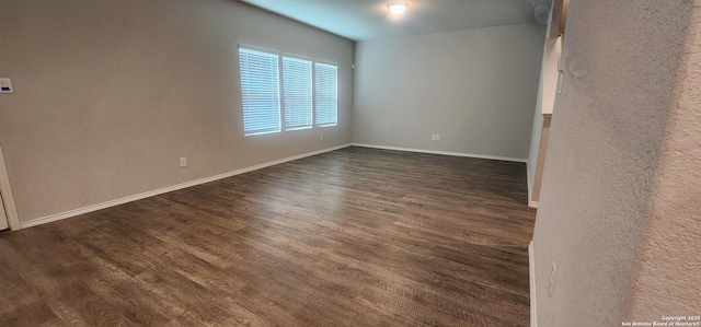 7115 Mesa Clfs, Converse, TX 78109 - spare room featuring dark wood-type flooring and a textured wall