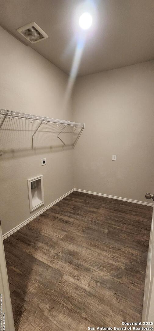 7115 Mesa Clfs, Converse, TX 78109 - laundry room featuring hookup for an electric dryer and dark wood-style flooring