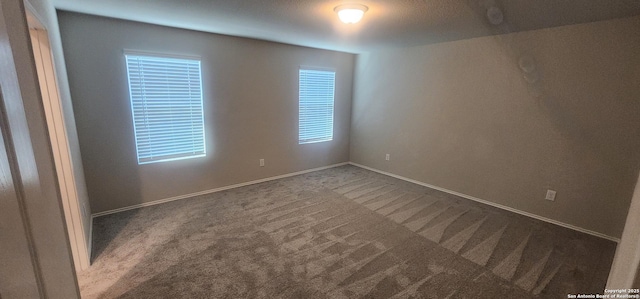 7115 Mesa Clfs, Converse, TX 78109 - spare room featuring dark carpet and baseboards