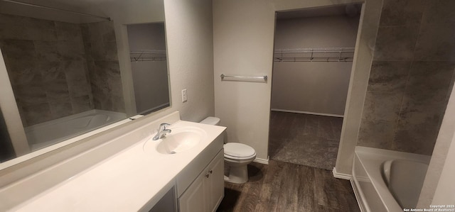 7115 Mesa Clfs, Converse, TX 78109 - bathroom with vanity, wood finished floors, and a walk in closet