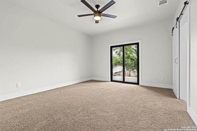 302 Bank, San Antonio, TX 78204 - unfurnished bedroom featuring a barn door, access to exterior, carpet floors, and ceiling fan