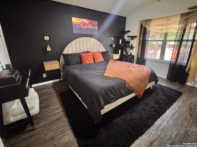 6914 Sandy Pt, San Antonio, TX 78244 - bedroom featuring wood finished floors, lofted ceiling, and an accent wall