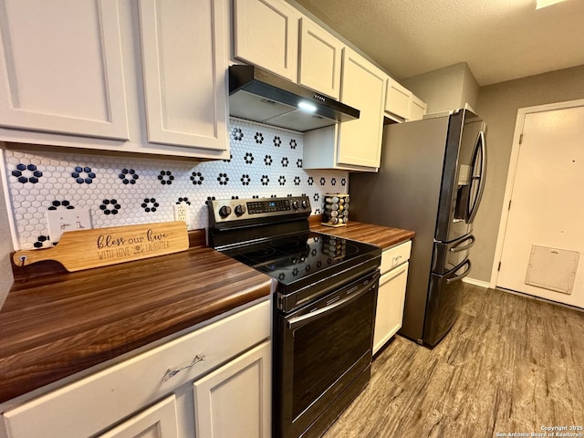 6914 Sandy Pt, San Antonio, TX 78244 - kitchen featuring black range with electric cooktop, wood counters, under cabinet range hood, and wood finished floors