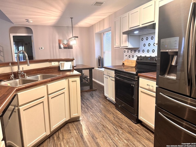 6914 Sandy Pt, San Antonio, TX 78244 - kitchen with stainless steel appliances, under cabinet range hood, wood counters, dark wood-style floors, and pendant lighting