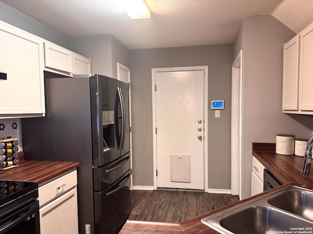 6914 Sandy Pt, San Antonio, TX 78244 - kitchen featuring wooden counters, dark wood finished floors, white cabinets, and black stove
